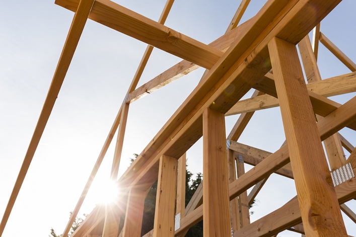roof trusses of new home construction with blue sky
